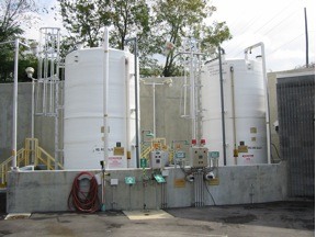 white containers holding iron salts for industrial odor control